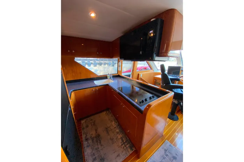 Slide: The Image of Modern kitchen interior on 2000 Compass 55 yacht, featuring sleek cabinetry and appliances. - 25
