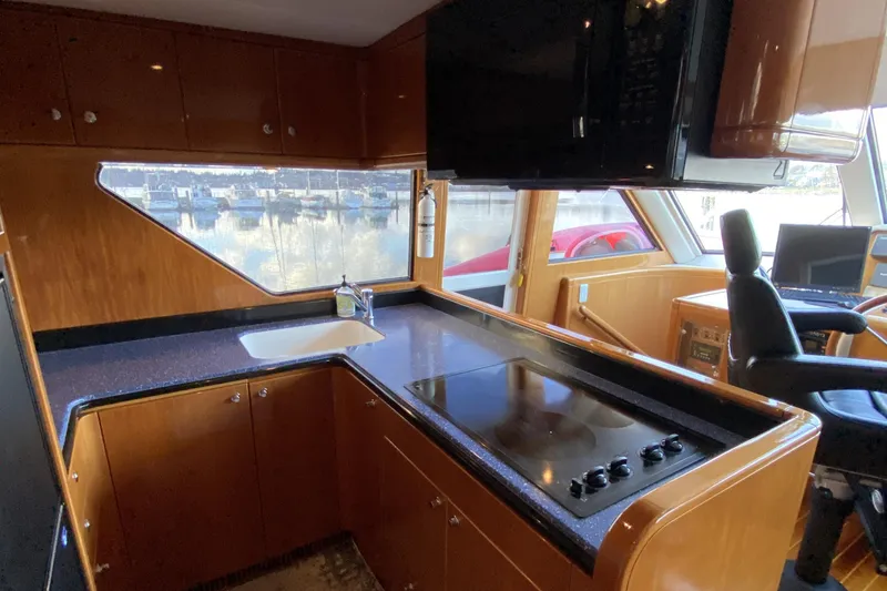 Slide: The Image of Luxurious kitchen interior of 2000 Compass 55 yacht with modern appliances and sleek design. - 26