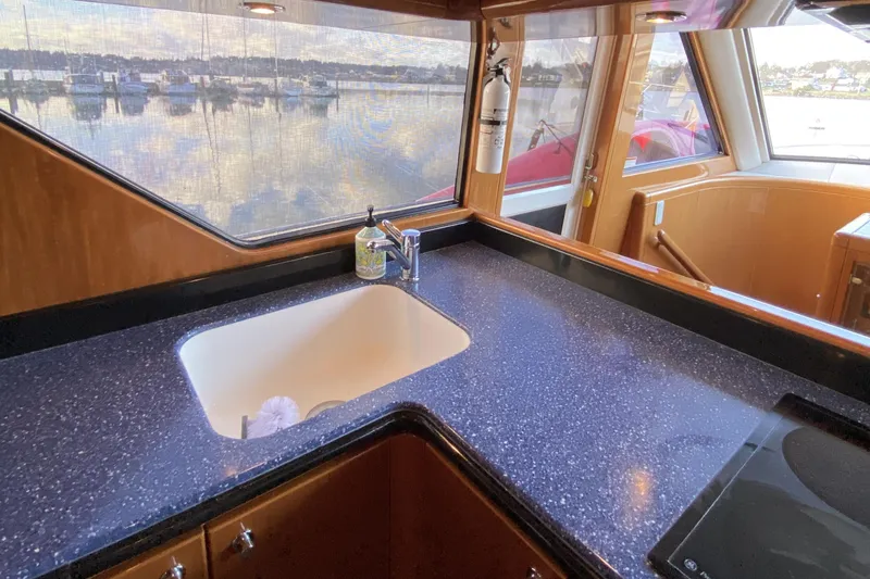 Slide: The Image of Luxurious kitchen area on a 2000 Compass 55 yacht with marina view. - 28