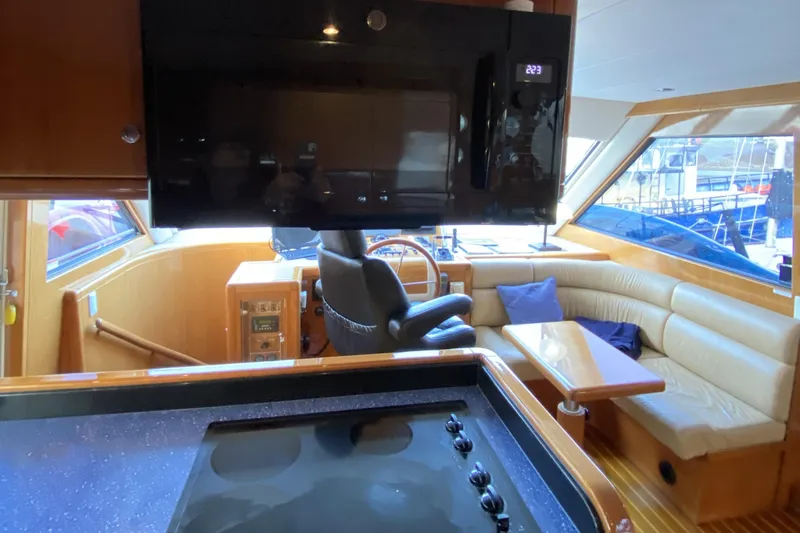 Slide: The Image of Interior of a 2000 Compass 55 yacht with modern kitchen and seating area. - 30