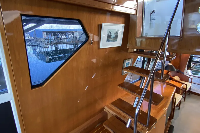 Slide: The Image of Interior of 2000 Compass 55 yacht with wooden stairs and window view. - 33