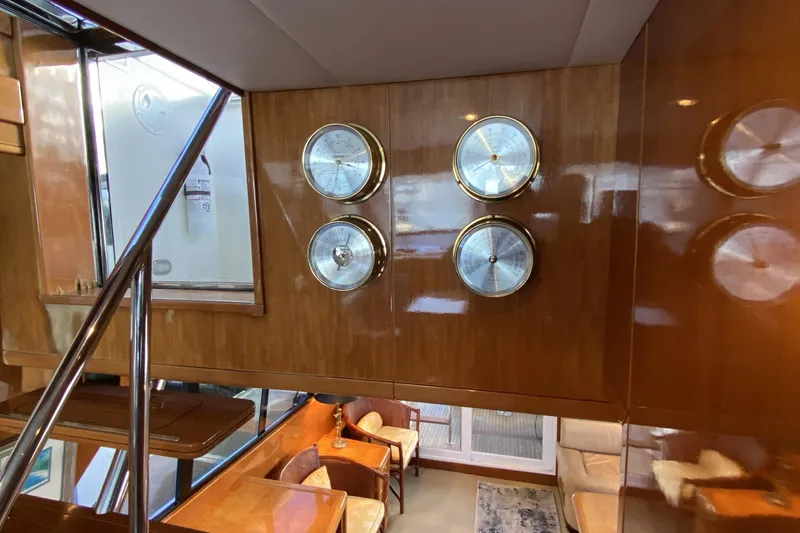 Slide: The Image of Interior of a 2000 Compass 55 yacht with wooden paneling and nautical instruments. - 34