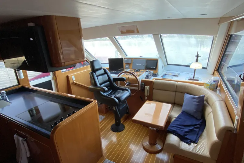 Slide: The Image of Luxurious interior of 2000 Compass 55 yacht with helm, seating, and kitchen area. - 35