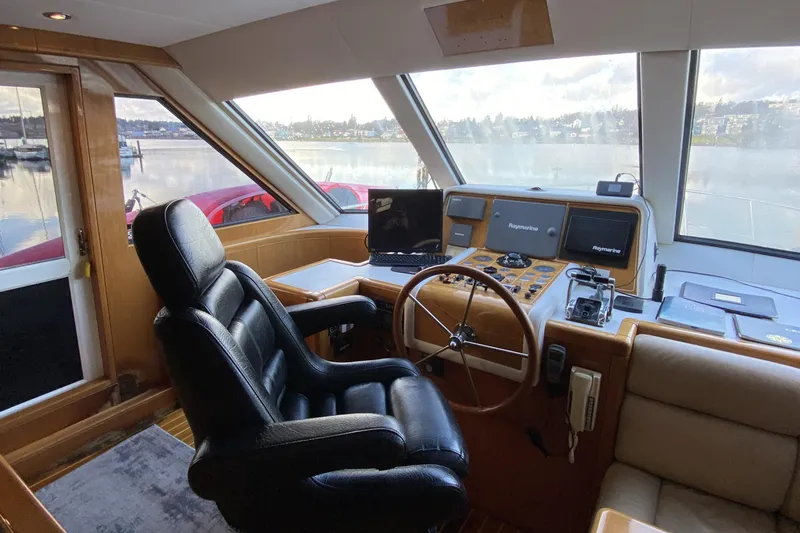 Slide: The Image of Luxurious helm of a 2000 Compass 55 yacht with leather seating and advanced navigation systems. - 36