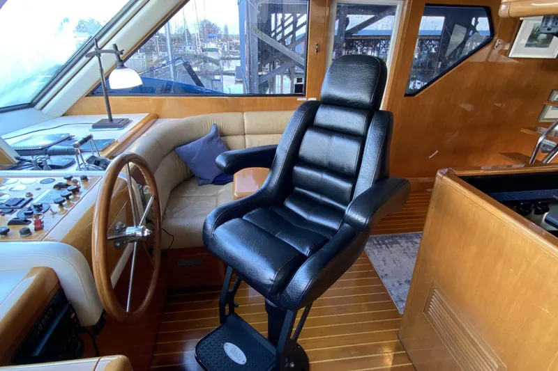 Slide: The Image of Luxurious interior of 2000 Compass 55 yacht with leather captain's chair and wooden steering wheel. - 37