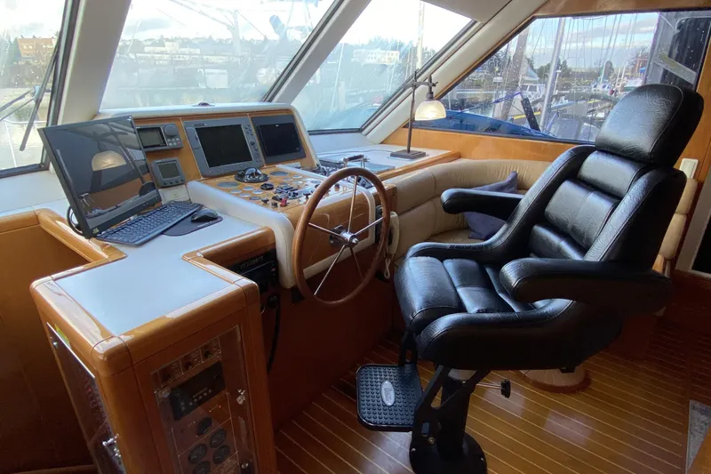Slide: The Image of Luxurious helm of 2000 Compass 55 yacht with leather chair and navigation equipment. - 38