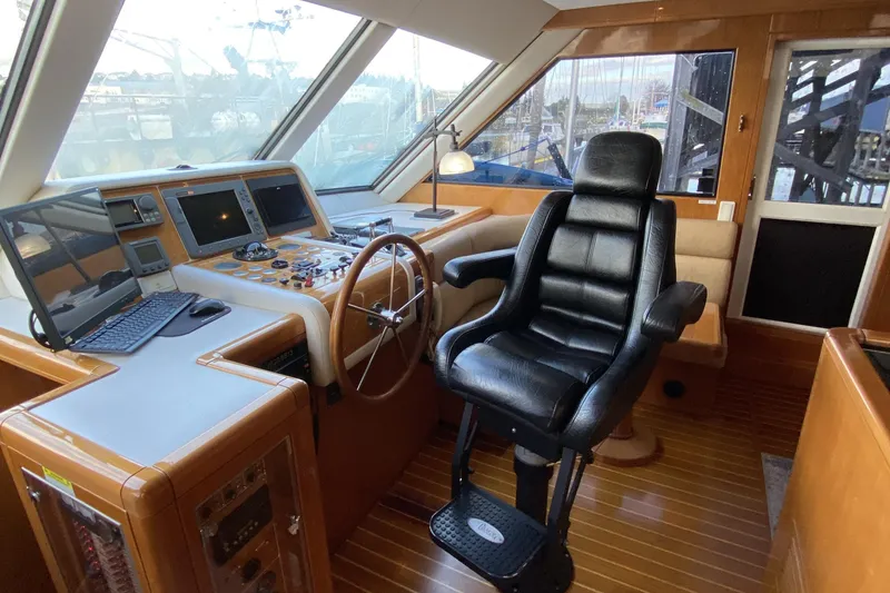 Slide: The Image of Luxurious helm of a 2000 Compass 55 yacht with leather captain's chair and navigation equipment. - 39