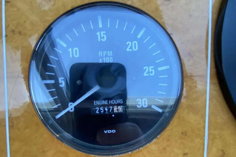 Slide: The Image of Compass 55 tachometer showing 2547.4 engine hours, RPM gauge, year 2000 model. - 42