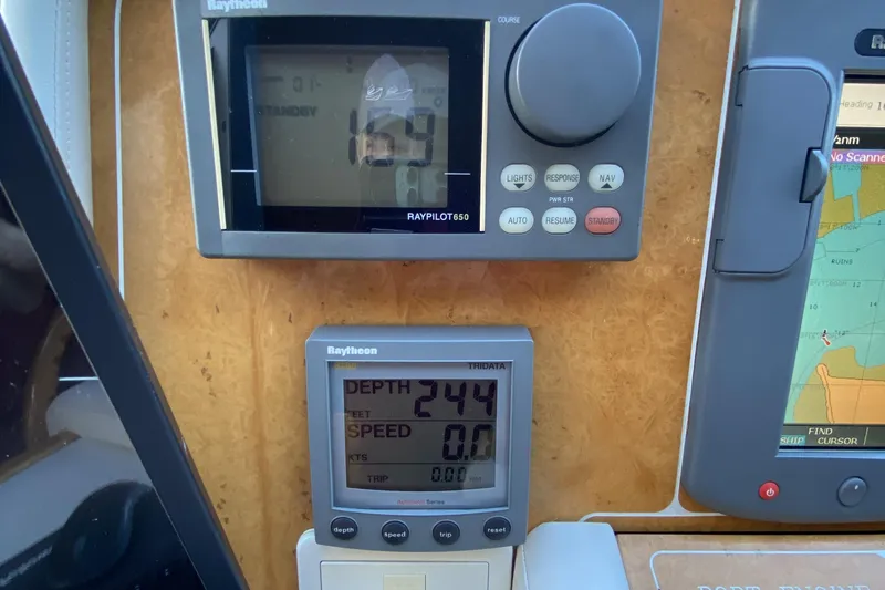 Slide: The Image of Boat navigation instruments displaying depth, speed, and course on a Compass 55, year 2000. - 45