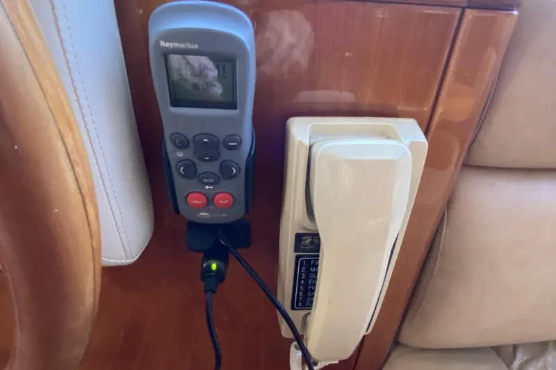 Slide: The Image of Remote control and phone mounted on wooden panel in Compass 55, 2000 model. - 47