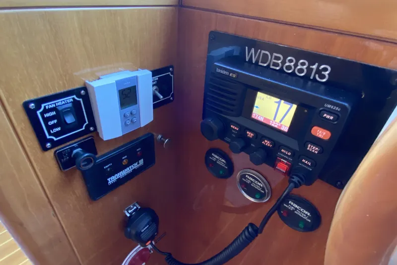 Slide: The Image of Control panel of a 2000 Compass 55 boat with radio and thermostat. - 48