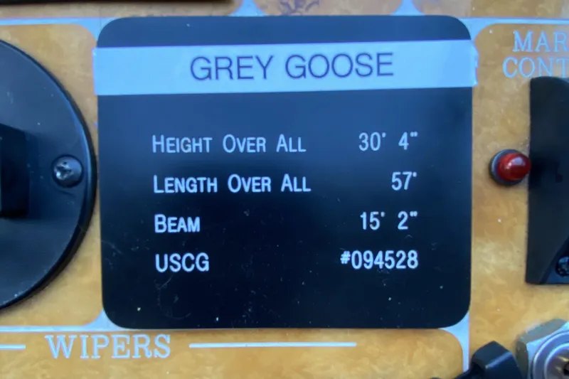 Slide: The Image of Control panel of a 2000 Compass 55 boat, labeled "Grey Goose," with dimensions and USCG number. - 49