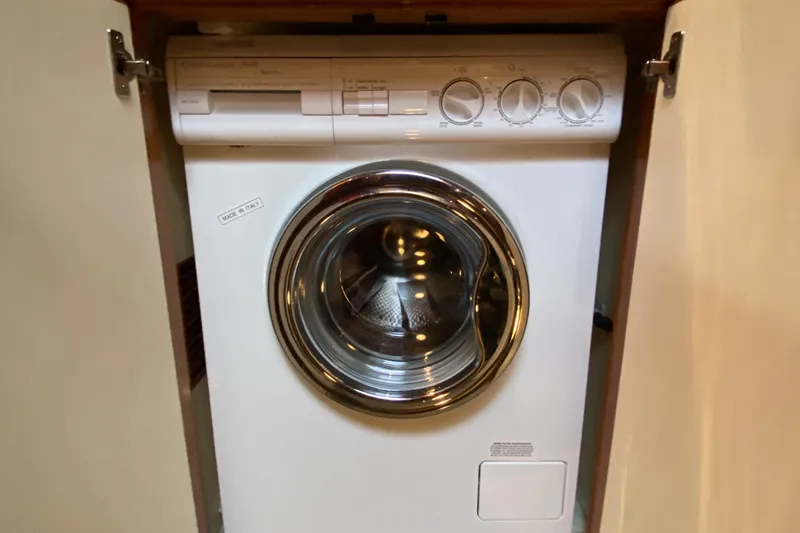 Slide: The Image of Front-loading Compass 55 washing machine from 2000, installed in a cabinet. - 55