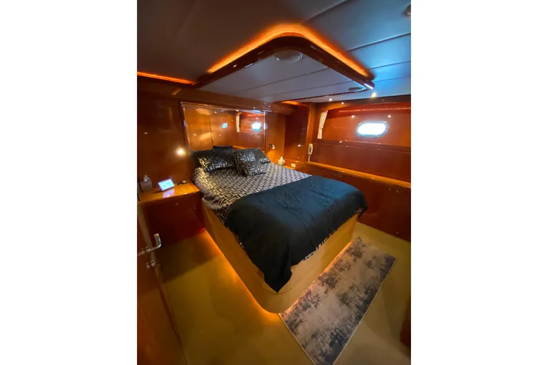 Slide: The Image of Luxurious bedroom interior on 2000 Compass 55 yacht with ambient lighting. - 57