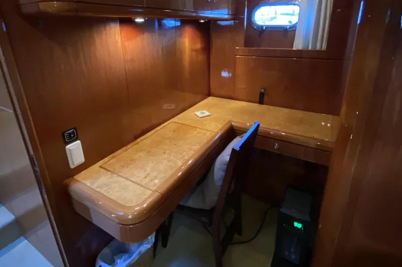 Slide: The Image of Luxurious wooden desk area in a 2000 Compass 55 yacht cabin. - 60