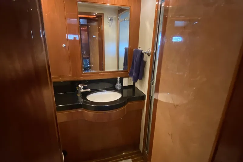 Slide: The Image of Luxurious bathroom in 2000 Compass 55 yacht with wood accents and modern fixtures. - 61