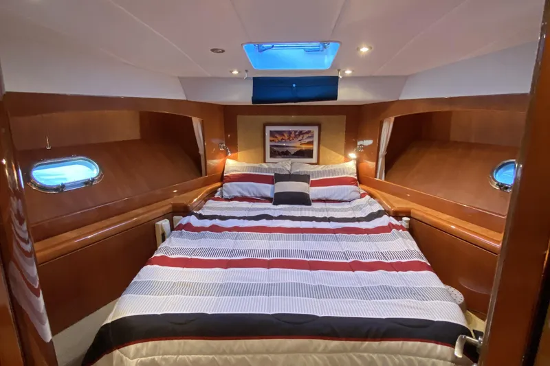 Slide: The Image of Luxurious cabin interior of 2000 Compass 55 yacht with cozy bed and porthole windows. - 64