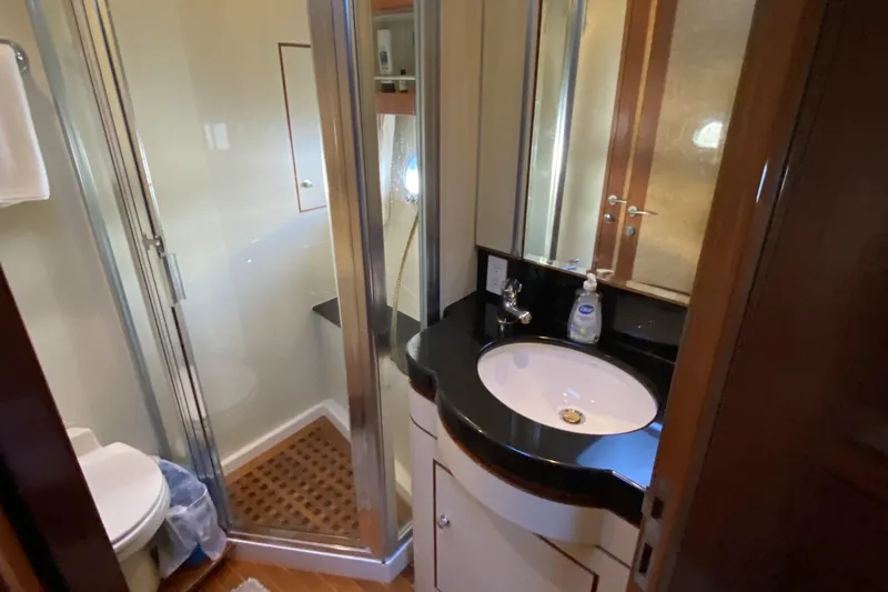Slide: The Image of Compact bathroom in 2000 Compass 55 yacht with shower, sink, and toilet. - 69