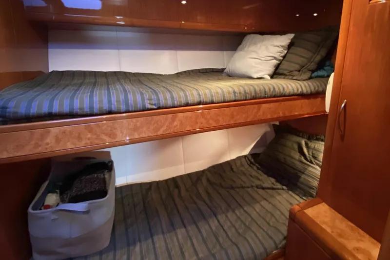 Slide: The Image of Bunk beds in a 2000 Compass 55 yacht cabin with striped bedding. - 70