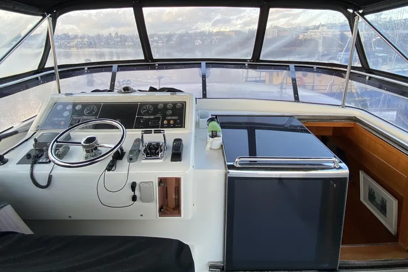 Slide: The Image of Cockpit of 2000 Compass 55 boat with steering wheel and control panel. - 72