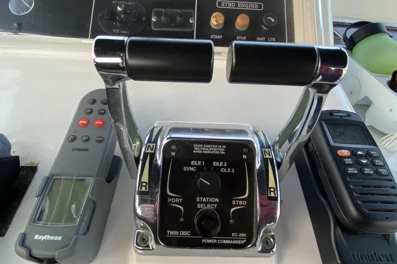Slide: The Image of Boat throttle controls and navigation equipment on a 2000 Compass 55. - 74