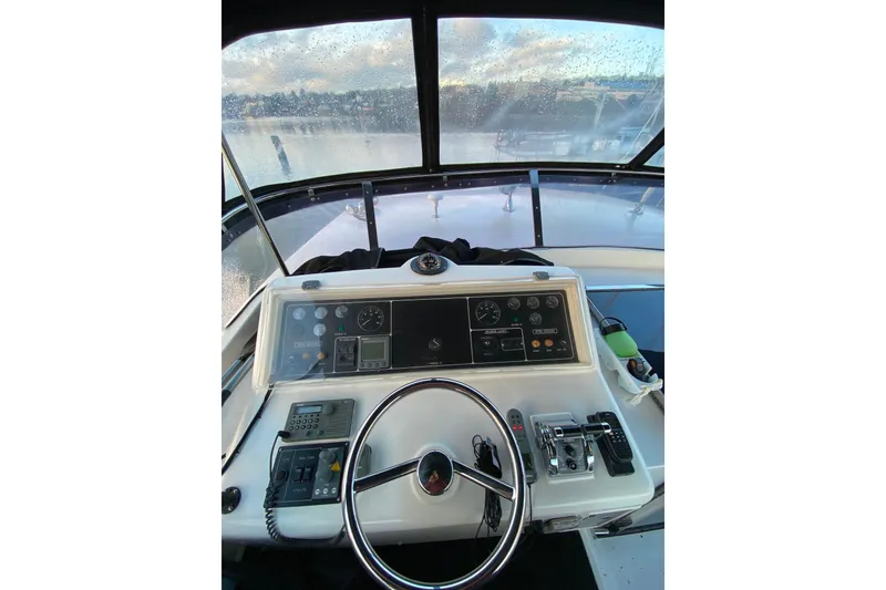 Slide: The Image of Steering console of a 2000 Compass 55 boat with gauges and controls. - 76