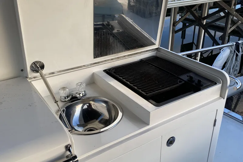Slide: The Image of Outdoor kitchen on a 2000 Compass 55 yacht with sink and grill. - 79