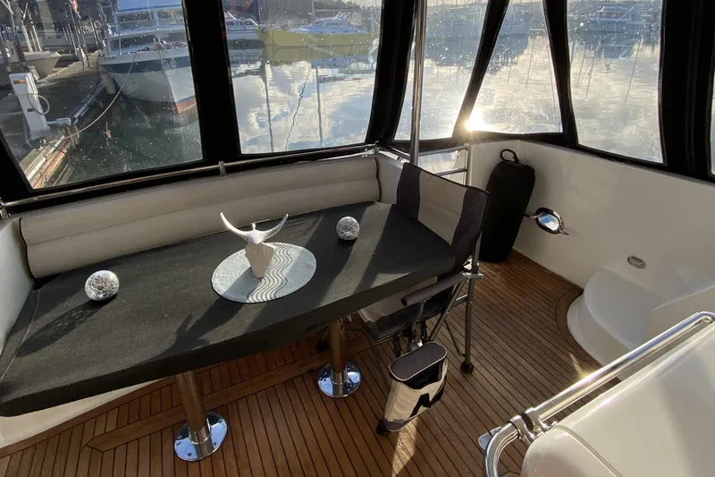 Slide: The Image of Interior of a 2000 Compass 55 yacht with elegant seating and decor. - 8