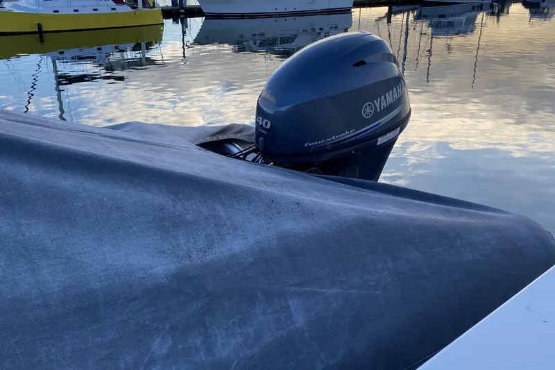 Slide: The Image of Covered boat with Yamaha outboard motor at marina, Compass 55 model, year 2000. - 81