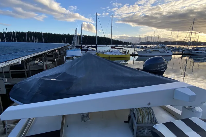 Slide: The Image of Boat docked at marina during sunset, featuring Compass 55 model from 2000. - 82