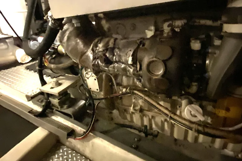 Slide: The Image of Engine compartment of a 2000 Compass 55, showing mechanical components and wiring. - 88
