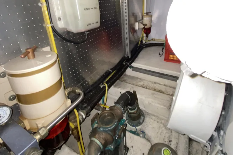 Slide: The Image of Engine room of a 2000 Compass 55 boat, featuring mechanical components and wiring. - 91
