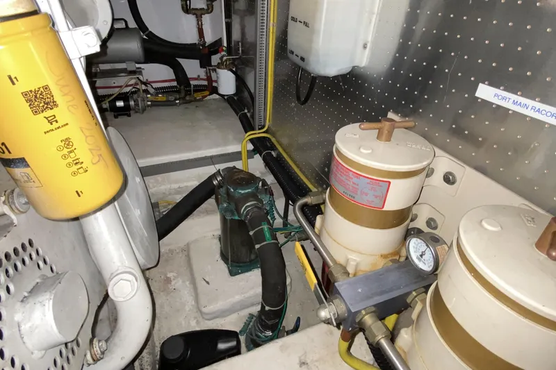 Slide: The Image of Engine room of a 2000 Compass 55 yacht with fuel filters and mechanical components. - 92