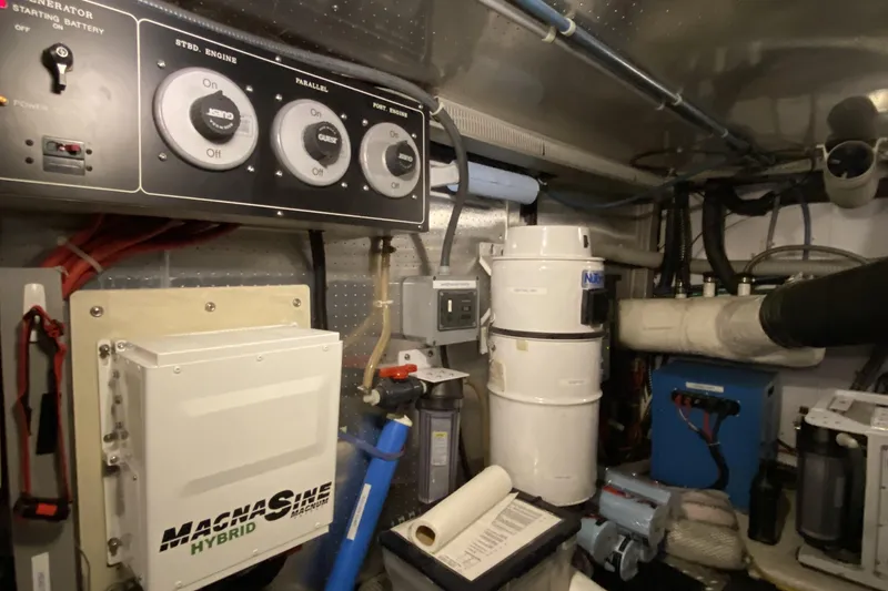 Slide: The Image of Engine room of a 2000 Compass 55 yacht with control panels and equipment. - 93