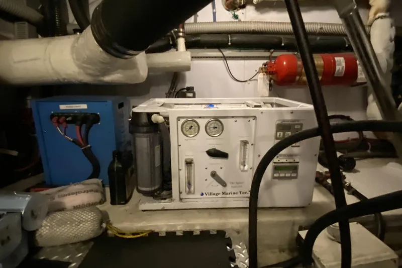 Slide: The Image of Engine room of a 2000 Compass 55 yacht with marine equipment and fire extinguisher. - 94
