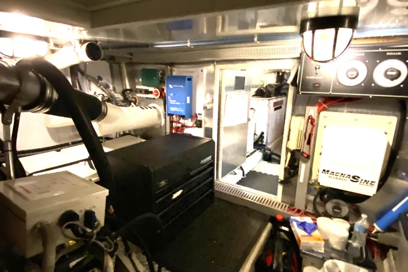 Slide: The Image of Engine room of a 2000 Compass 55 yacht with various equipment and controls. - 95