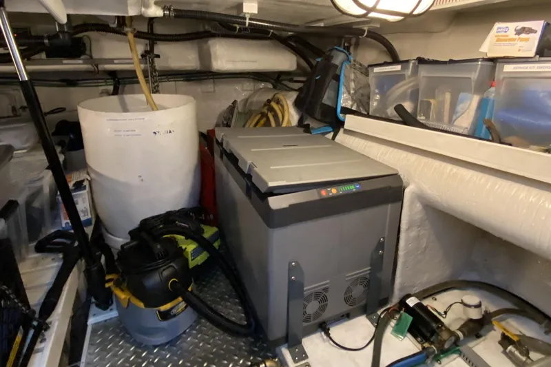 Slide: The Image of Storage area in a 2000 Compass 55 boat with equipment and supplies. - 97