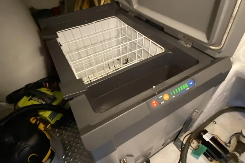 Slide: The Image of Open Compass 55 cooler with control panel, year 2000 model, in a storage area. - 98