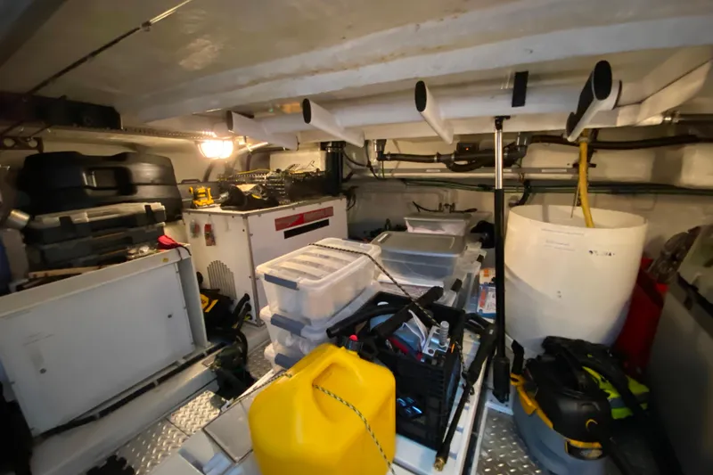 Slide: The Image of Engine room of 2000 Compass 55 boat with tools and equipment storage. - 99