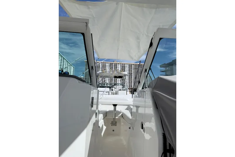 Slide: The Image of 2022 Pursuit DC 266 Dual Console boat interior with cityscape background. - 14