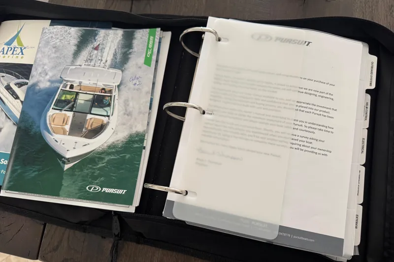 Slide: The Image of Open binder with Pursuit DC 266 Dual Console 2022 brochure and documents. - 15