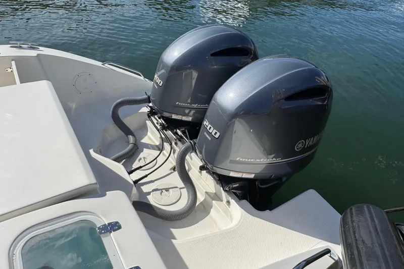 Slide: The Image of 2022 Pursuit DC 266 Dual Console with twin Yamaha outboard engines on water. - 17