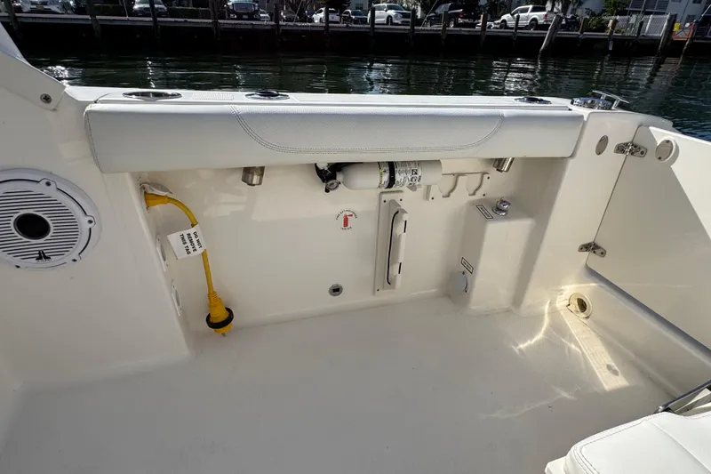 Slide: The Image of 2022 Pursuit DC 266 Dual Console boat interior with seating and equipment. - 23