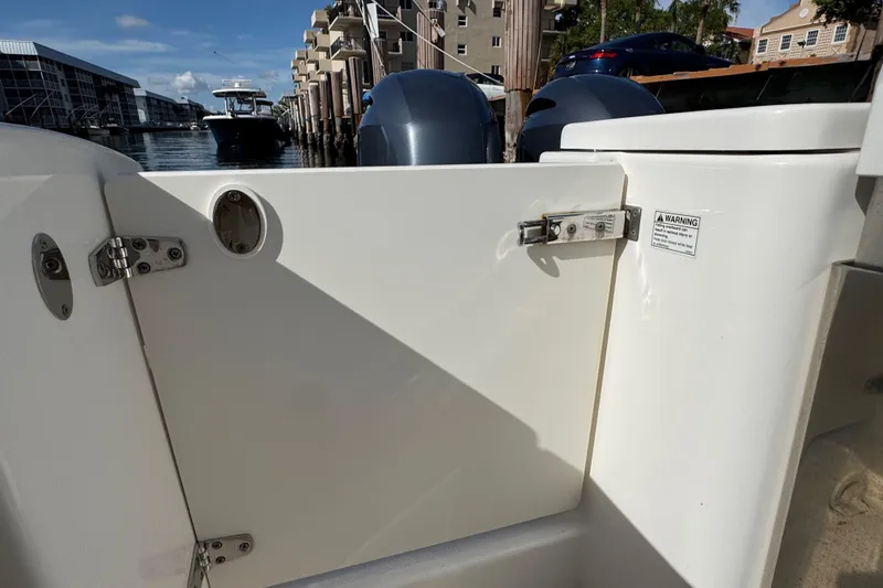 Slide: The Image of 2022 Pursuit DC 266 Dual Console boat interior with docked marina view. - 25