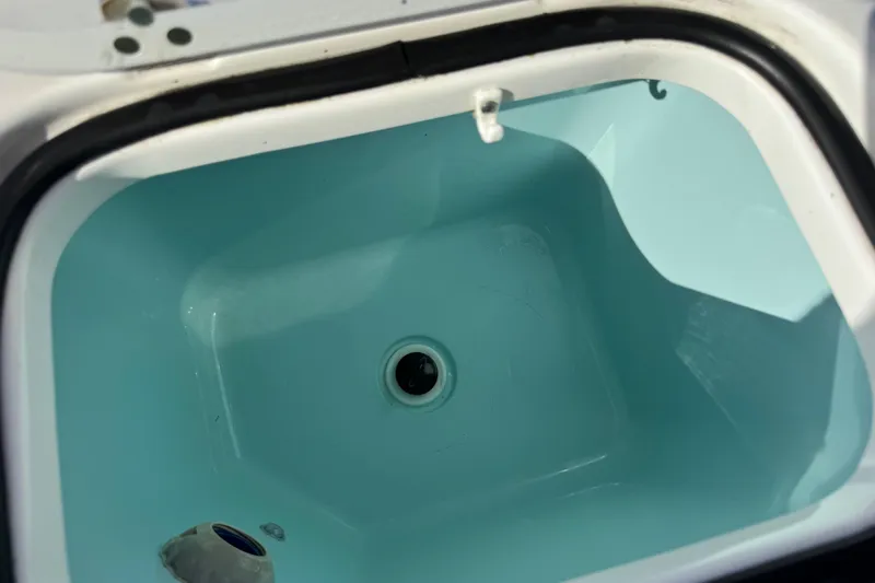 Slide: The Image of Livewell compartment of 2022 Pursuit DC 266 Dual Console boat. - 31