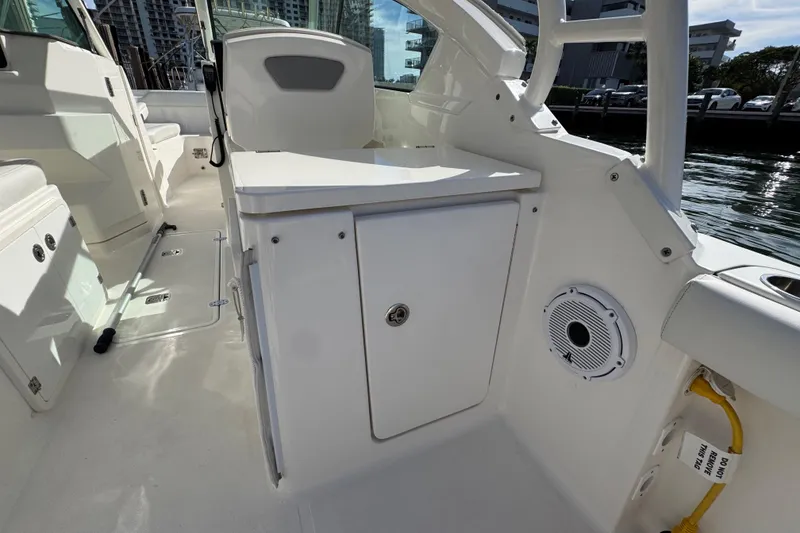 Slide: The Image of 2022 Pursuit DC 266 Dual Console boat interior with storage and speaker. - 34