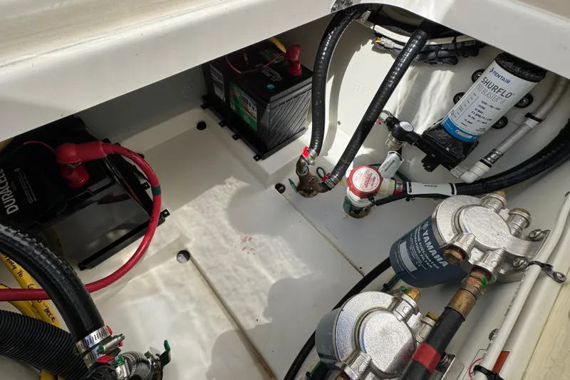 Slide: The Image of 2022 Pursuit DC 266 Dual Console engine compartment with batteries and fuel filters. - 38