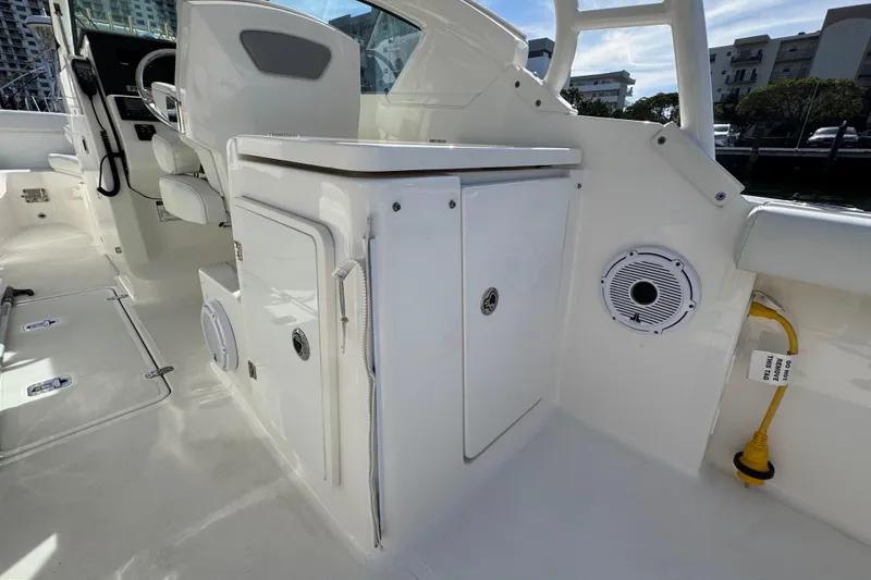 Slide: The Image of 2022 Pursuit DC 266 Dual Console interior with seating and storage compartments. - 45