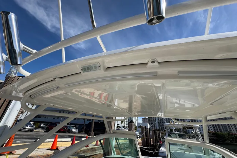 Slide: The Image of 2022 Pursuit DC 266 Dual Console boat with sleek white hardtop and rod holders. - 47
