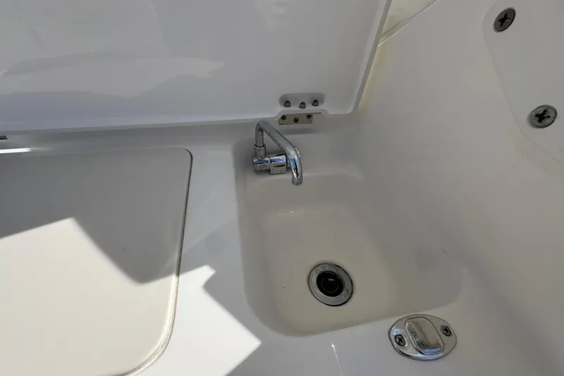 Slide: The Image of 2022 Pursuit DC 266 Dual Console boat sink with chrome faucet. - 48